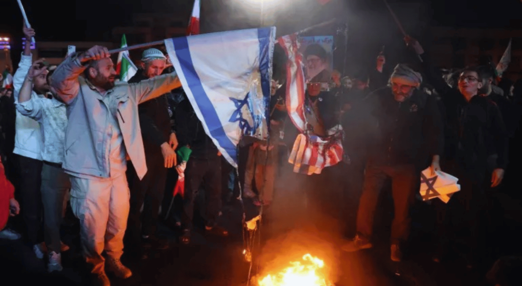 তেহরানের এনকেলাব স্কোয়ারে দুই সপ্তাহের যুদ্ধবিরতি চুক্তির ঘোষণাকে স্বাগত জানিয়ে ইরানিরা মার্কিন ও ইসরায়েলি পতাকা পুড়িয়েছে । ছবি: এএফপি