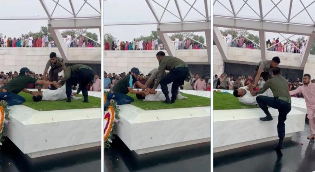 রাজধানীর জিয়া উদ্যানে জিয়াউর রহমান ও খালেদা জিয়ার কবরে উঠে আত্মহত্যার চেষ্টা করছে এক যুবক। এসময় তাকেঁ বাধা দিচ্ছেন আনসার সদস্যরা। ছবি: সংগৃহীত