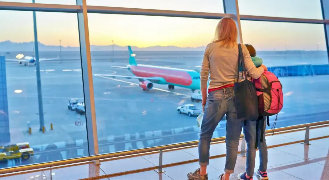 mother-and-child-watching-airplanes-at-airport-win