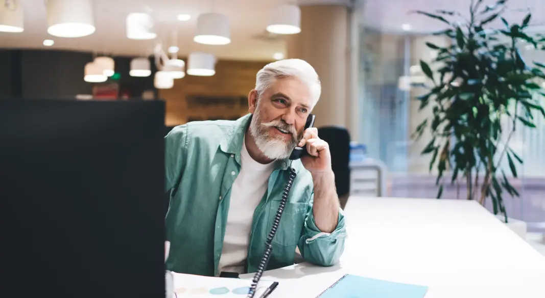 man-with-beard-talking-on-landline-phone