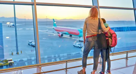 mother-and-child-watching-airplanes-at-airport-win